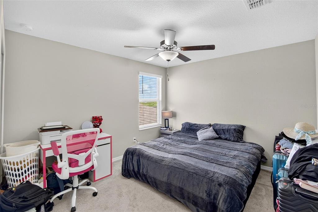 31783 Sun Kettle Loop Wesley Chapel, FL 33545 - Photo 45 of 73 a bedroom with a bed and furniture