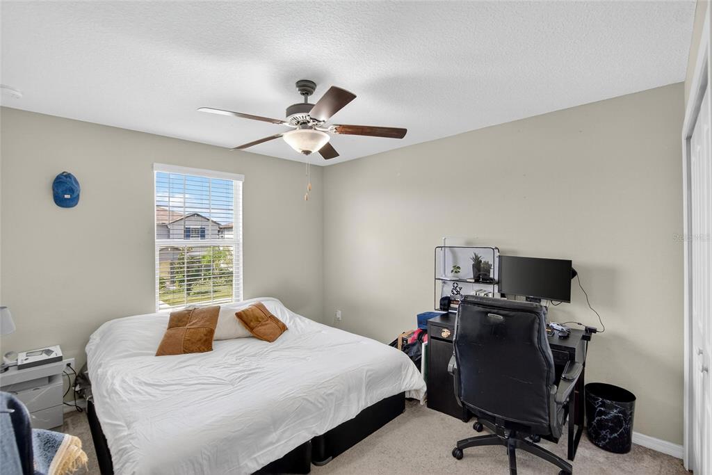 31783 Sun Kettle Loop Wesley Chapel, FL 33545 - Photo 48 of 73 a bedroom with a bed and a window