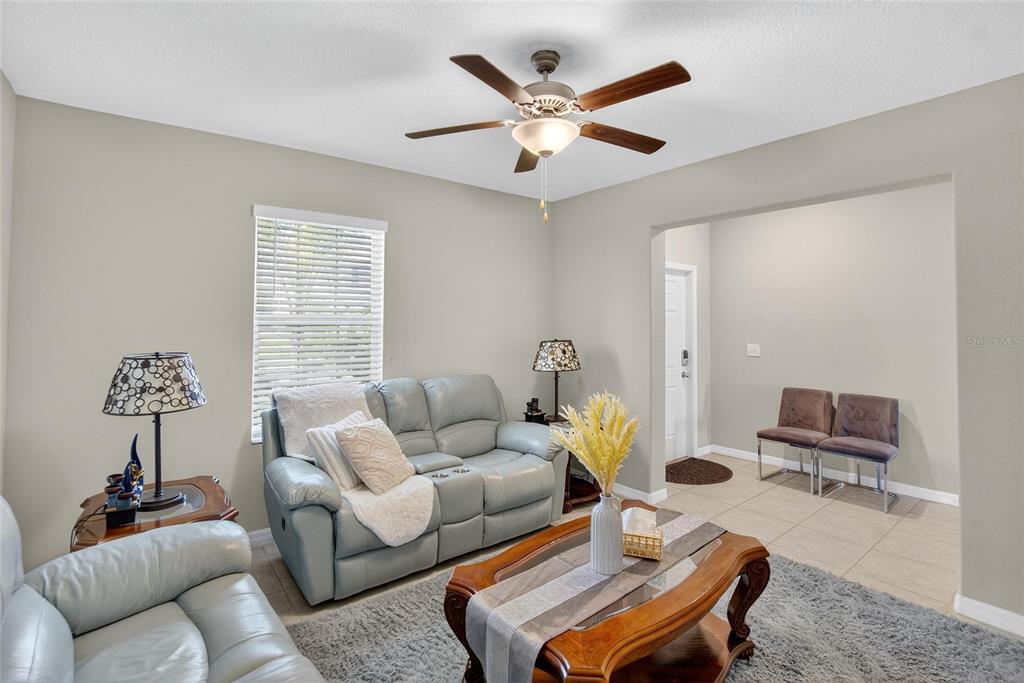 31783 Sun Kettle Loop Wesley Chapel, FL 33545 - Photo 5 of 73 a living room with furniture a rug and a window