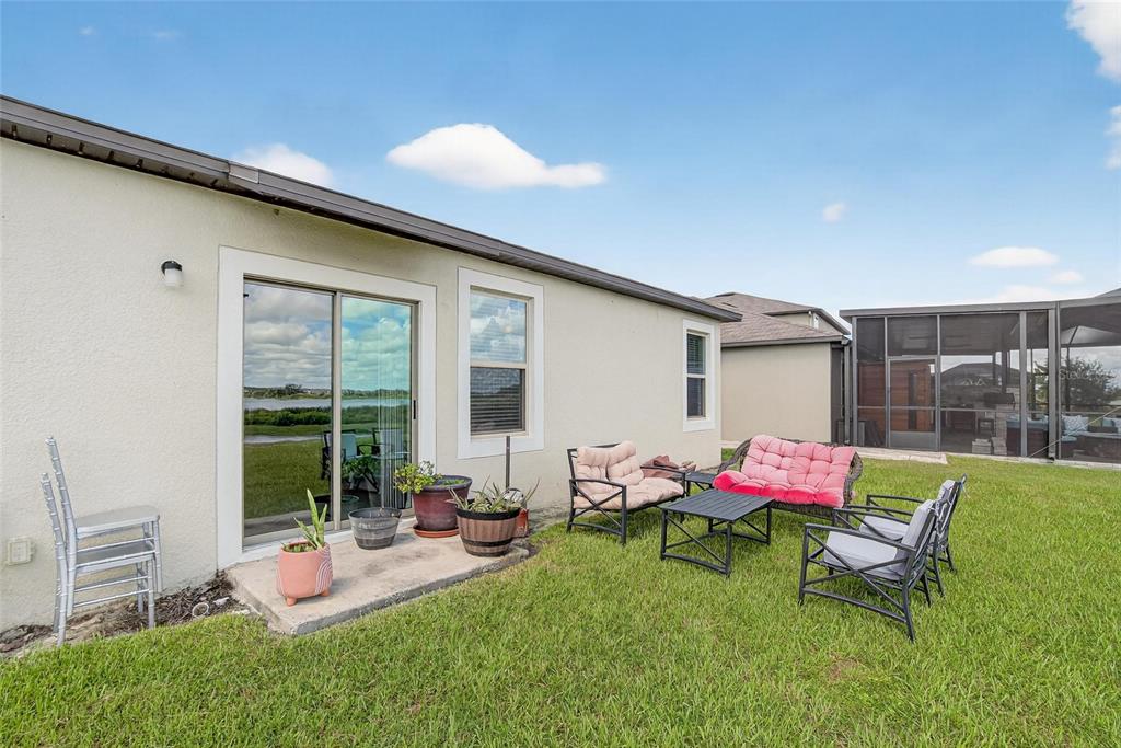 31783 Sun Kettle Loop Wesley Chapel, FL 33545 - Photo 53 of 73 a view of a house with backyard sitting area and garden