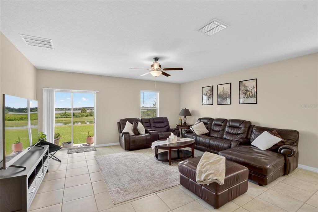 31783 Sun Kettle Loop Wesley Chapel, FL 33545 - Photo 8 of 73 a living room with furniture and a large window