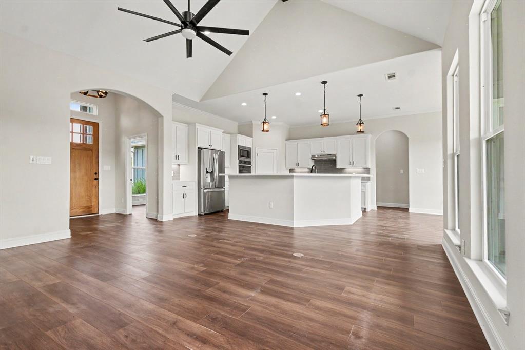 530 P R 491 Leonard, TX 75452 - Photo 11 of 35 Expansive living area featuring vaulted ceilings, wood-finish flooring, and abundant natural light from multiple windows