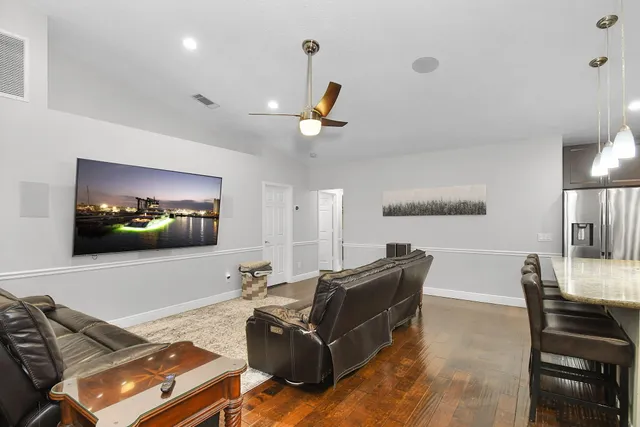 a bedroom with a bed and a ceiling fan