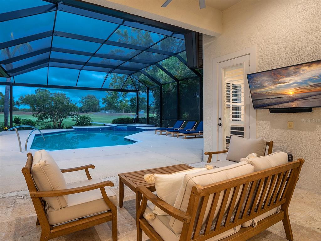7431 Greystone Street Lakewood Ranch, FL 34202 - Photo 21 of 85 a outdoor dining space with furniture and umbrella
