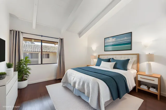 a bedroom with a bed and a large window