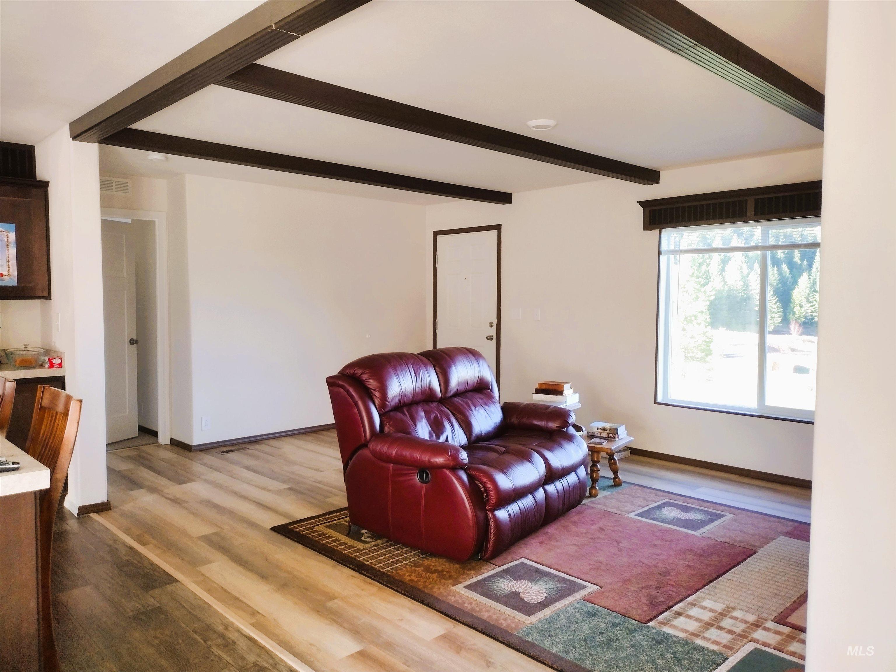 142 Shenandoah Third Street Kamiah, ID 83536 - Photo 24 of 50 Living room featuring beam ceiling and light wood finished floors