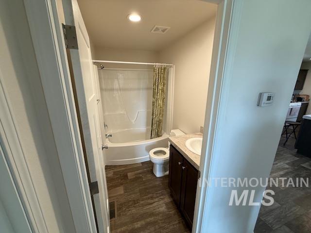 142 Shenandoah Third Street Kamiah, ID 83536 - Photo 39 of 50 Bathroom featuring vanity, dark wood finished floors, shower / tub combo, and recessed lighting