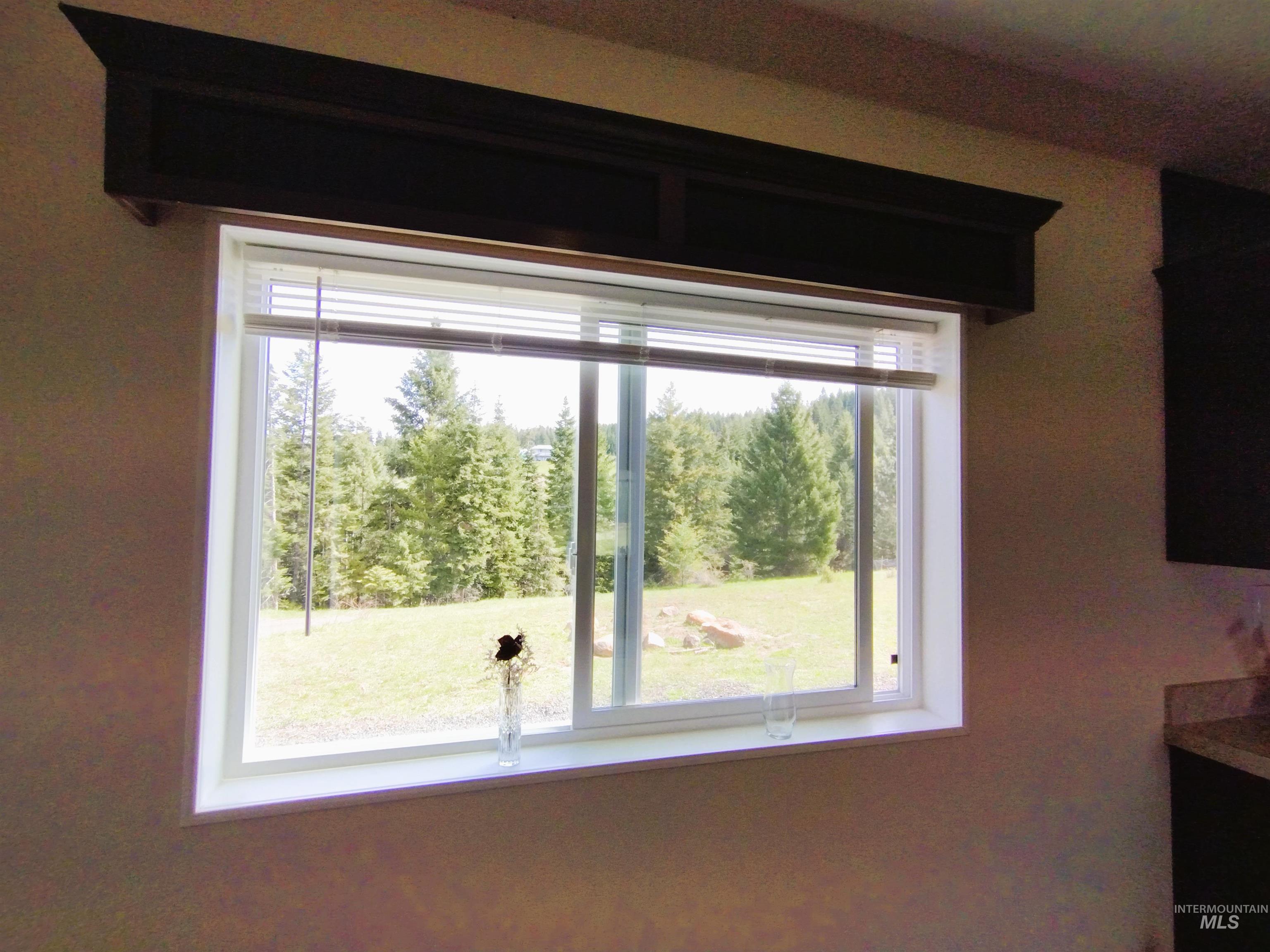 142 Shenandoah Third Street Kamiah, ID 83536 - Photo 44 of 50 Window featuring a dark wood valance, white trim, and direct natural light