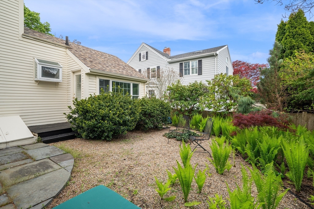 26 Pickwick Road Marblehead, MA 01945 - Photo 35 of 40 a view of backyard with potted plants and a bench