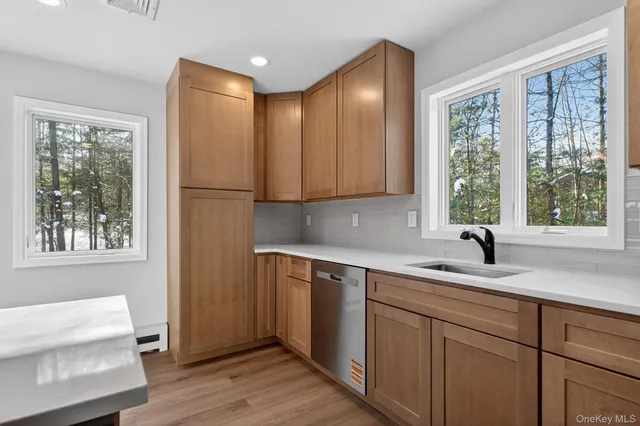 a kitchen with a sink cabinets and window