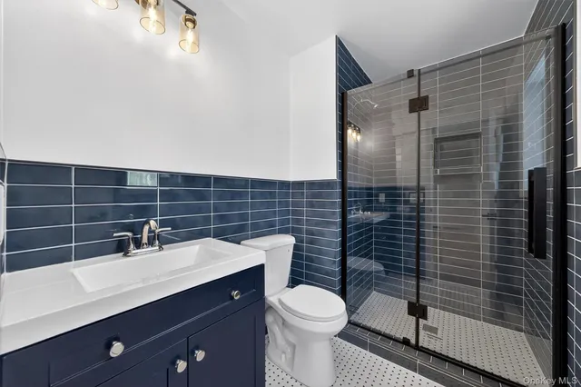 a bathroom with a sink toilet and mirror