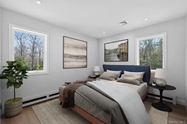 a bedroom with bed and a potted plant