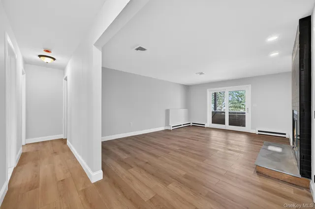 wooden floor in an empty room with a window