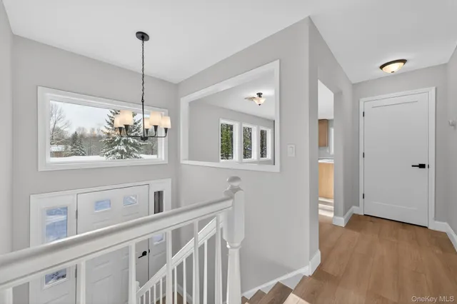 a view of an entryway with wooden floor