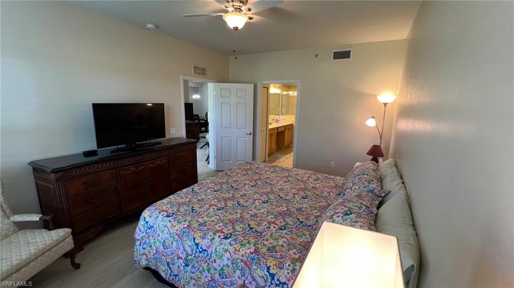 5705 Mayflower Way, Unit 1402 Ave Maria, FL 34142 - Photo 22 of 35 a bedroom with a bed and a flat screen tv