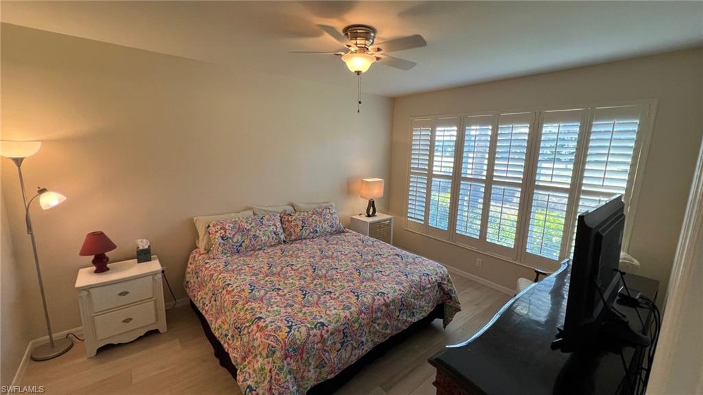 5705 Mayflower Way, Unit 1402 Ave Maria, FL 34142 - Photo 23 of 35 a bedroom with a bed dresser and a window