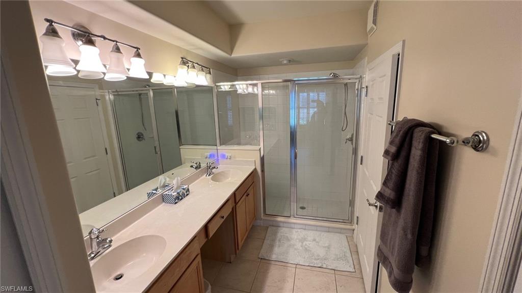 5705 Mayflower Way, Unit 1402 Ave Maria, FL 34142 - Photo 24 of 35 a bathroom with a sink a mirror and a shower