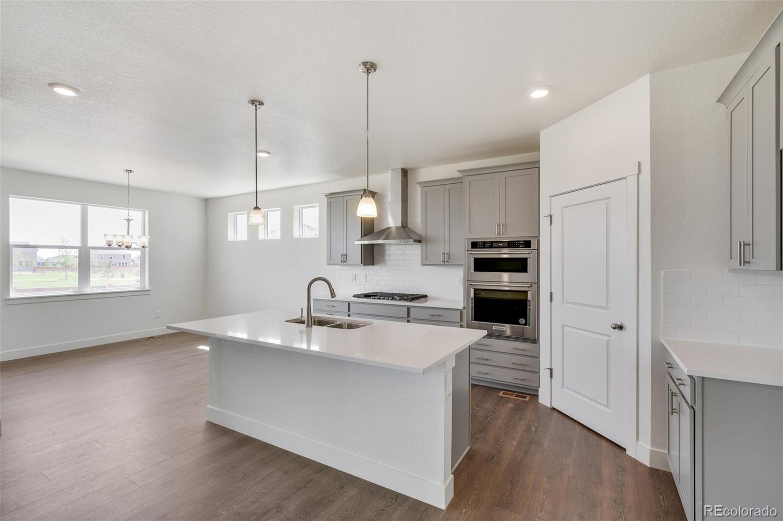 1105 Clara View Drive Berthoud, CO 80513 - Photo 12 of 35 a kitchen with kitchen island a sink stove and refrigerator