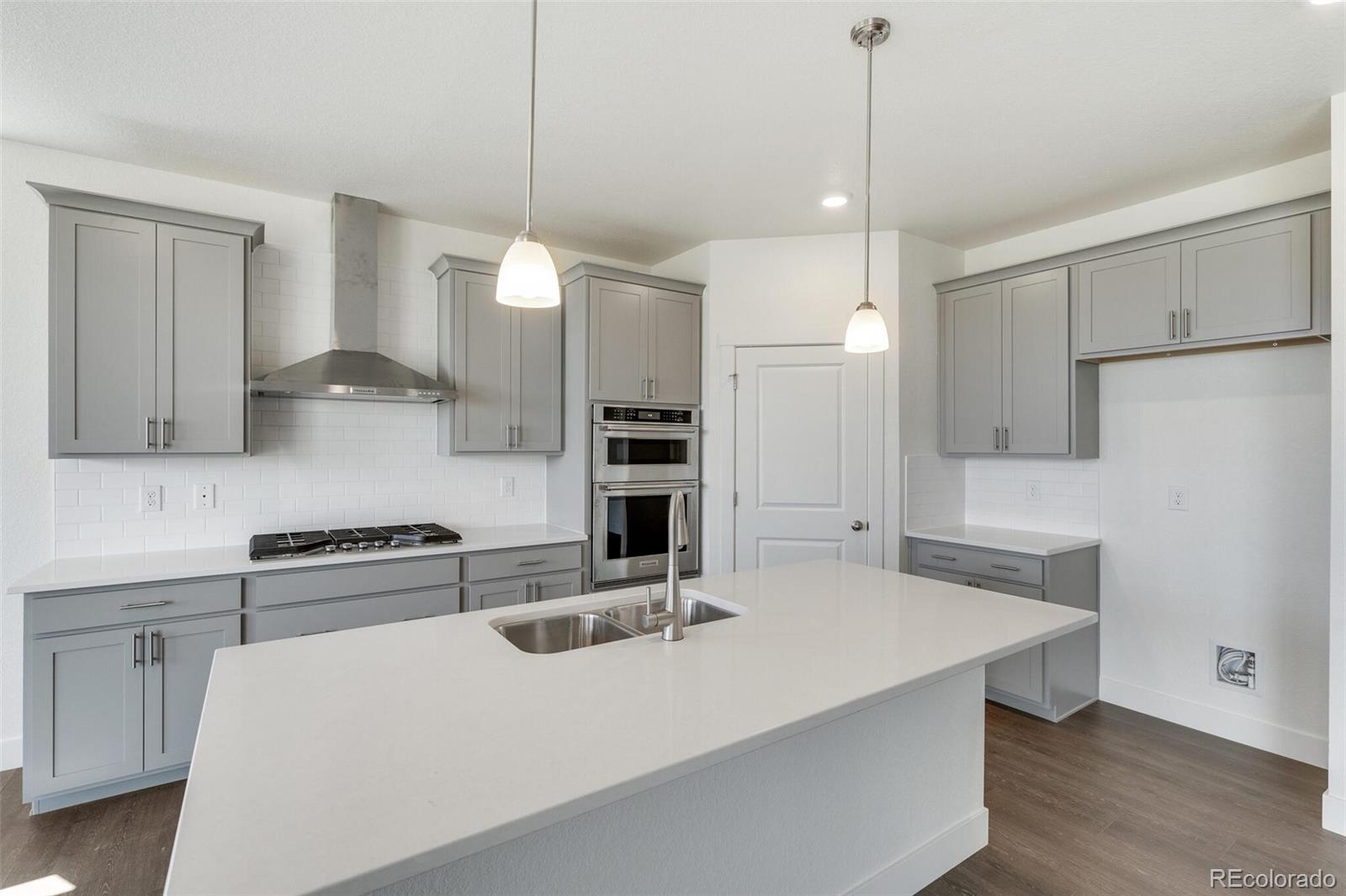1105 Clara View Drive Berthoud, CO 80513 - Photo 14 of 35 a kitchen with kitchen island a sink stainless steel appliances and cabinets