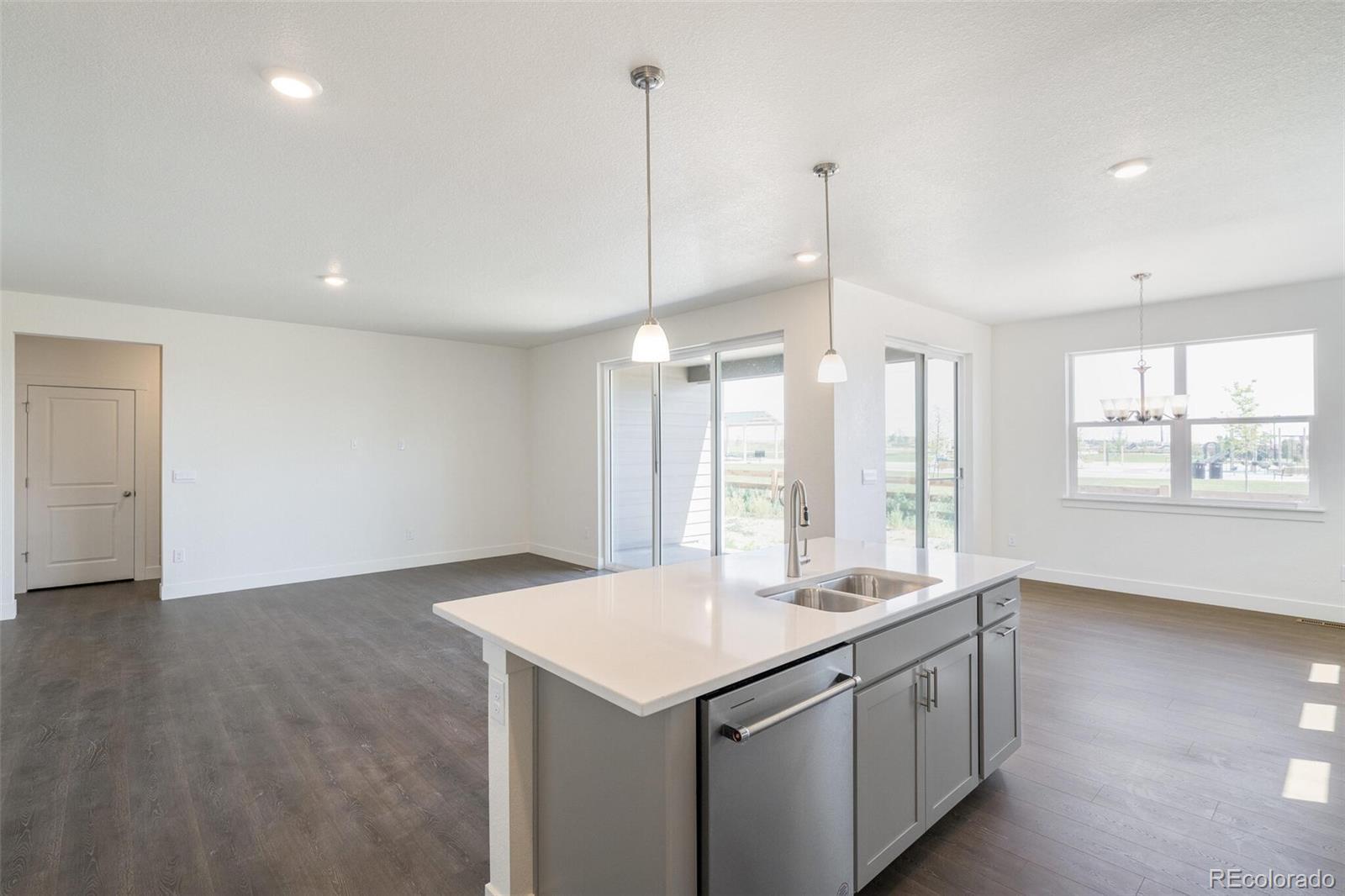 1105 Clara View Drive Berthoud, CO 80513 - Photo 16 of 35 a kitchen with granite countertop a sink and a wooden floor