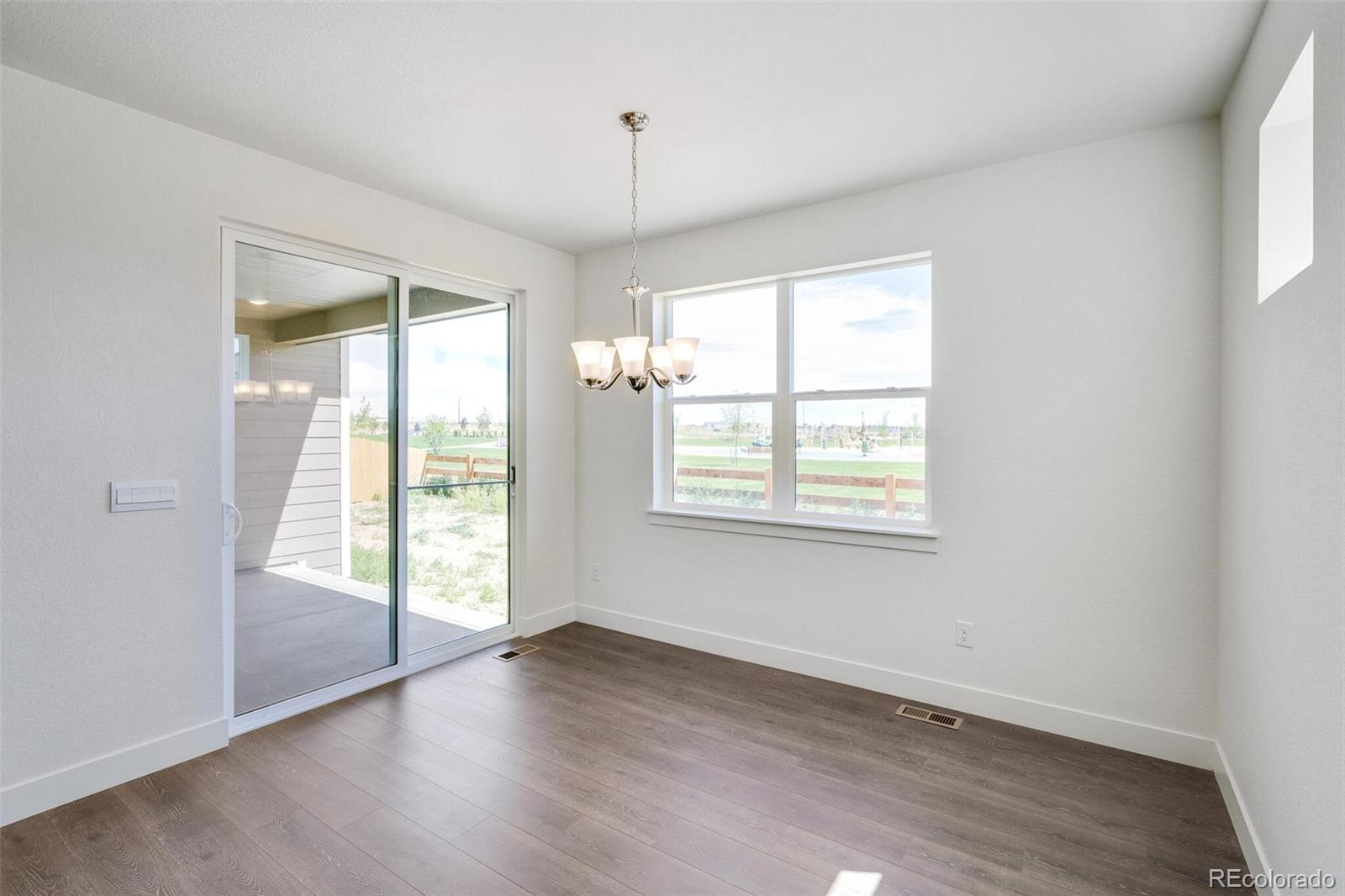 1105 Clara View Drive Berthoud, CO 80513 - Photo 17 of 35 an empty room with wooden floor and windows