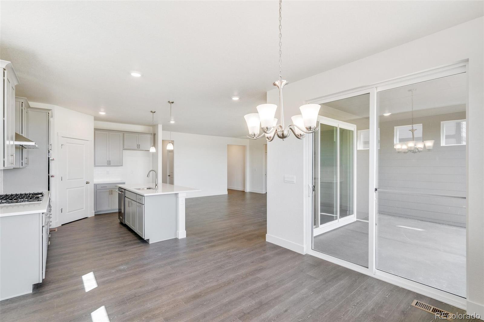 1105 Clara View Drive Berthoud, CO 80513 - Photo 18 of 35 a view of a kitchen and dining room with wooden floor
