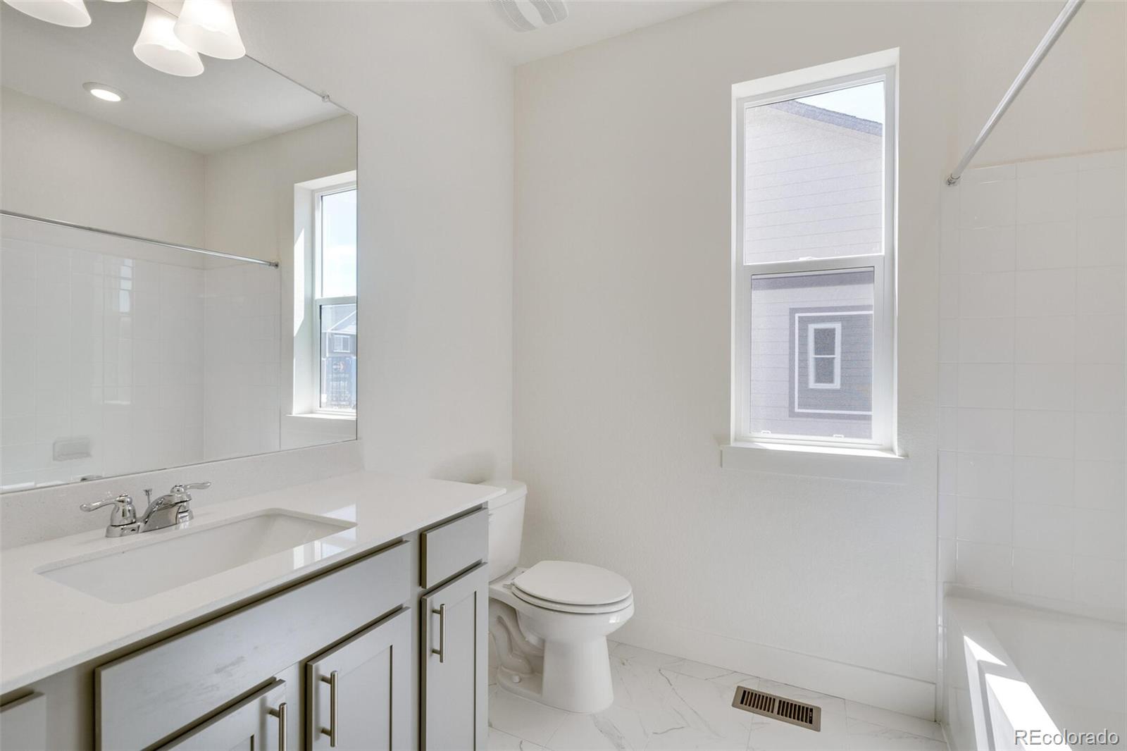 1105 Clara View Drive Berthoud, CO 80513 - Photo 25 of 35 a bathroom with a sink a toilet and a mirror