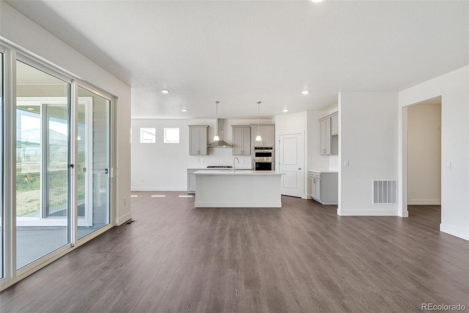1105 Clara View Drive Berthoud, CO 80513 - Photo 6 of 35 a large kitchen with white cabinets and wooden floor
