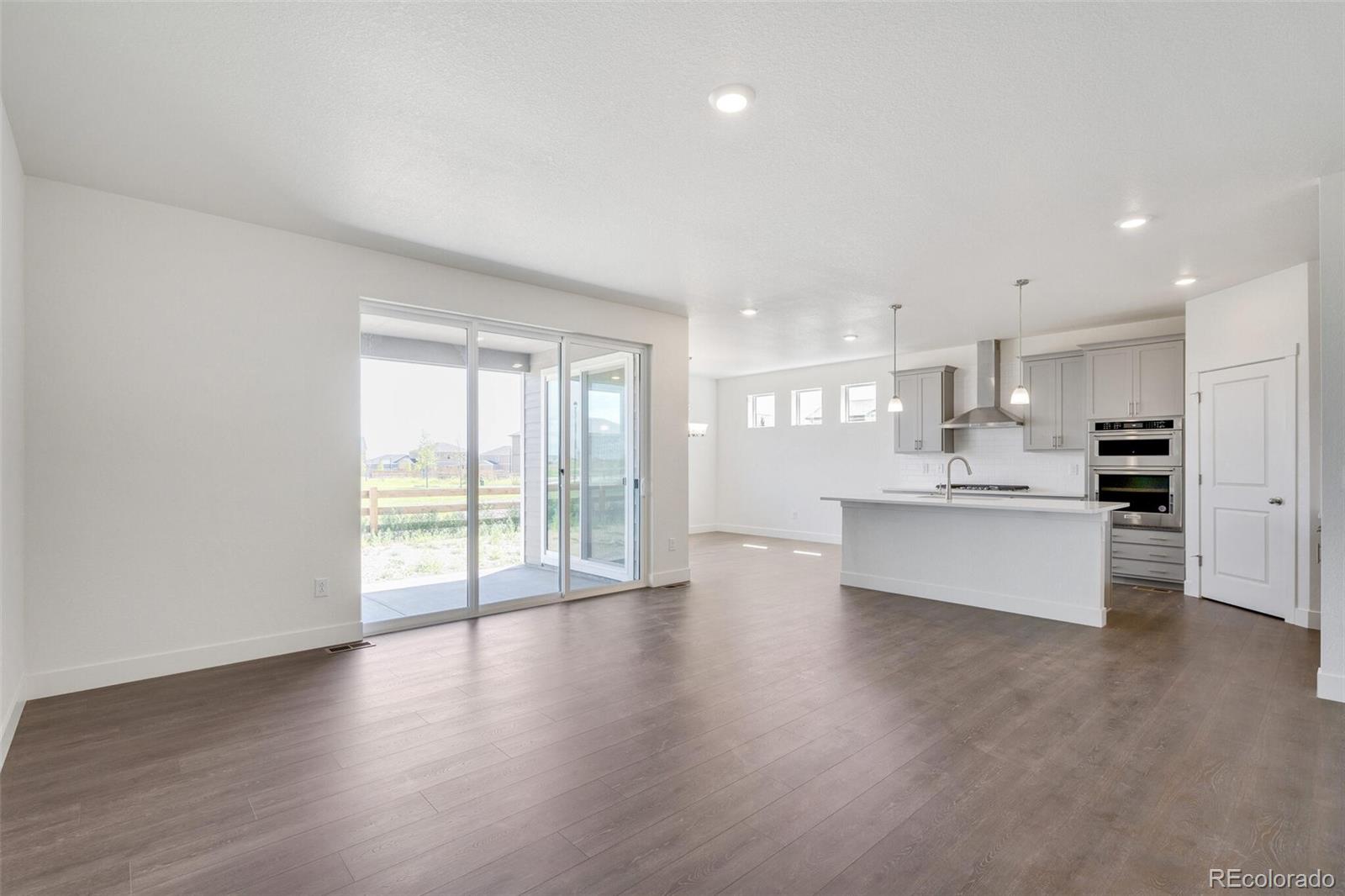 1105 Clara View Drive Berthoud, CO 80513 - Photo 7 of 35 a large kitchen with stainless steel appliances granite countertop a large counter top a wooden floors and a large window