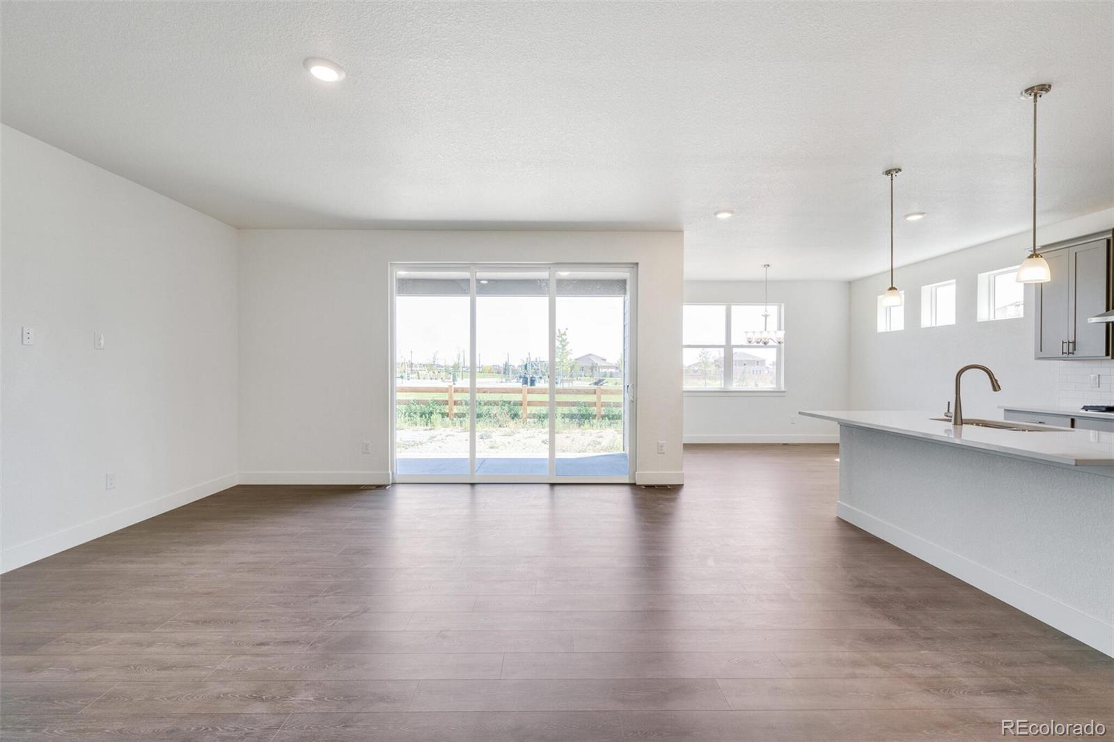 1105 Clara View Drive Berthoud, CO 80513 - Photo 10 of 35 a view of an empty room with a window and wooden floor