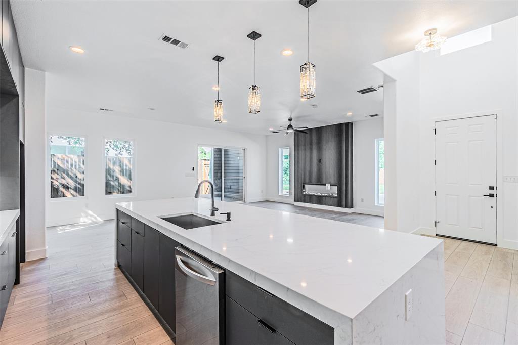 4309 Sylvester Street Dallas, TX 75219 - Photo 12 of 39 a kitchen with stainless steel appliances granite countertop a sink a counter space and a window