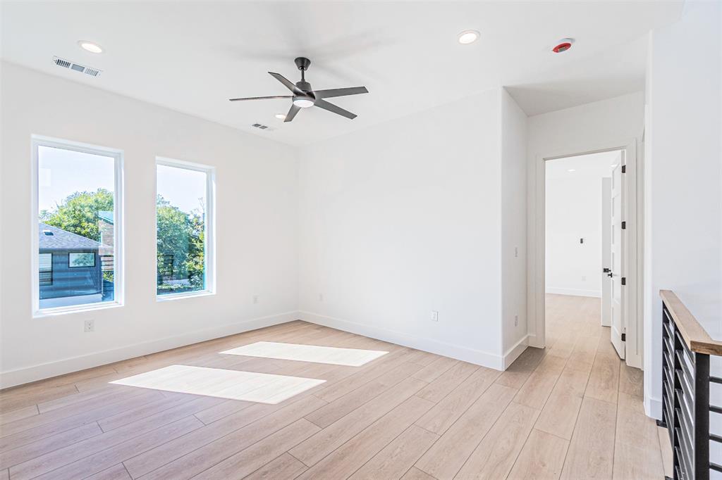 4309 Sylvester Street Dallas, TX 75219 - Photo 15 of 39 a view of empty room with wooden floor and fan