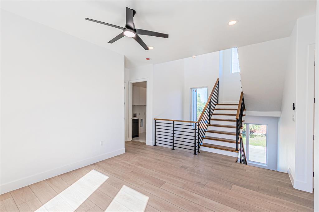 4309 Sylvester Street Dallas, TX 75219 - Photo 16 of 39 a view of a room with wooden floor and white walls