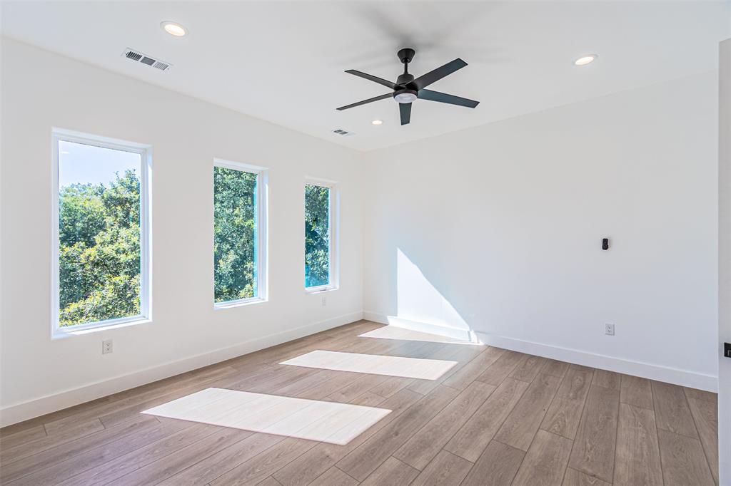4309 Sylvester Street Dallas, TX 75219 - Photo 19 of 39 wooden floor in an empty room with a window