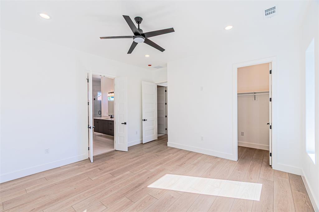 4309 Sylvester Street Dallas, TX 75219 - Photo 20 of 39 a view of a room with wooden floor and ceiling fan