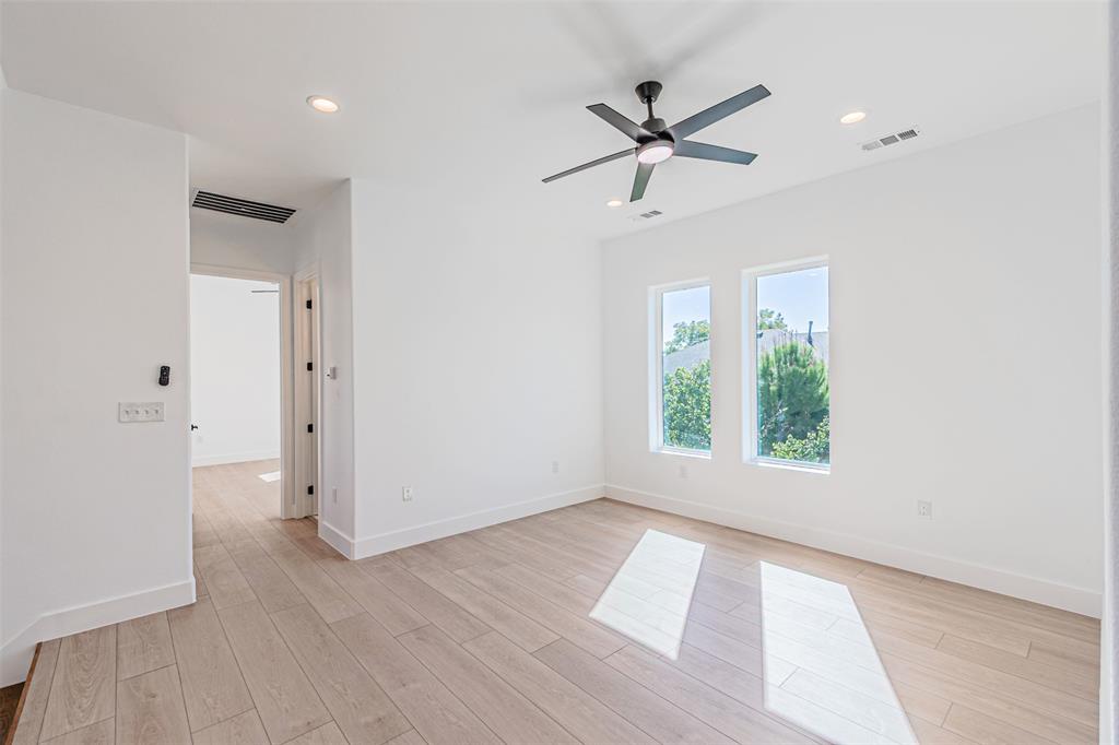 4309 Sylvester Street Dallas, TX 75219 - Photo 24 of 39 a view of empty room with wooden floor and fan