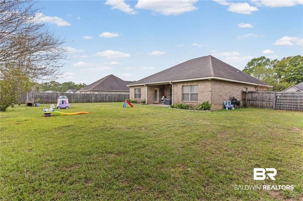 2570 Pecan Pointe Drive Semmes, AL 36575 - Photo 19 of 22 Back of house with brick siding, a fenced backyard, and a patio area