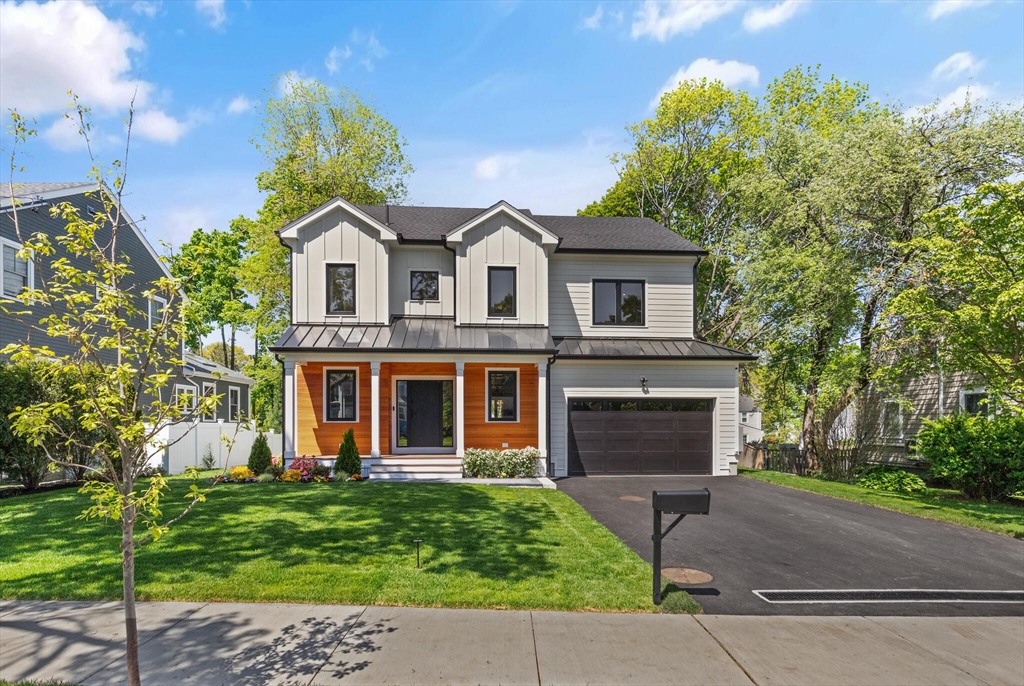 33 Barbara Road Newton, MA 02465 - Photo 1 of 42 a front view of a house with a garden and plants