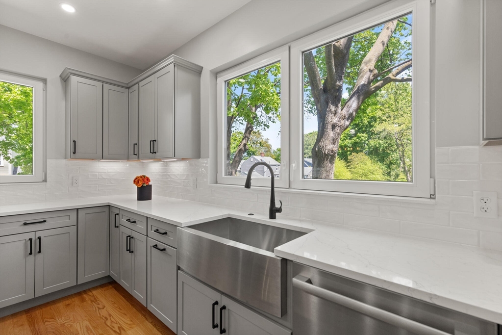 33 Barbara Road Newton, MA 02465 - Photo 13 of 42 a kitchen with a sink window and cabinets