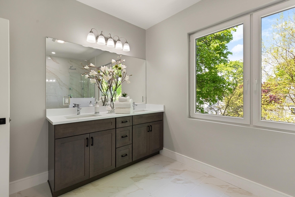 33 Barbara Road Newton, MA 02465 - Photo 24 of 42 a bathroom with a double vanity sink and large mirror