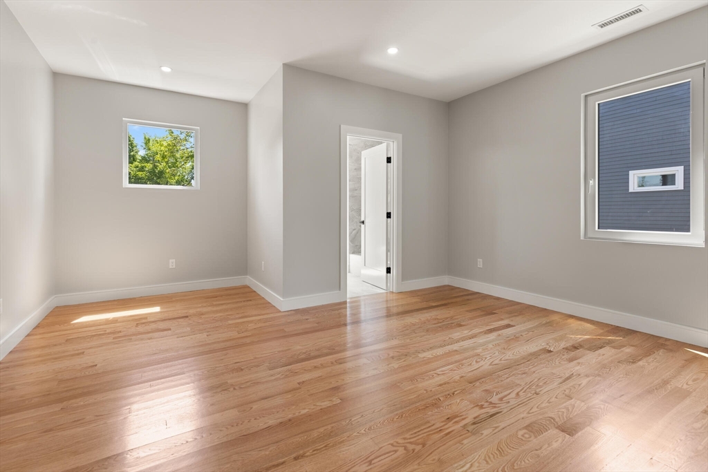 33 Barbara Road Newton, MA 02465 - Photo 26 of 42 a view of empty room with wooden floor and fan
