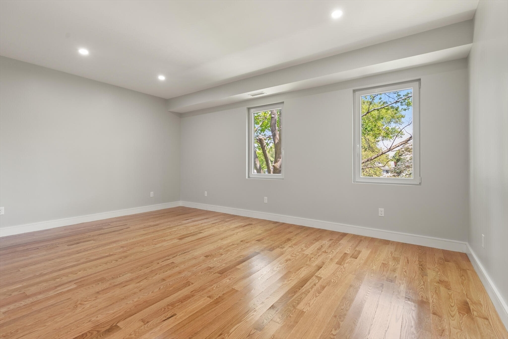 33 Barbara Road Newton, MA 02465 - Photo 28 of 42 an empty room with wooden floor and window