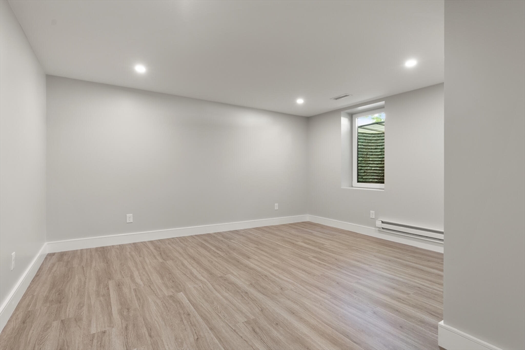 33 Barbara Road Newton, MA 02465 - Photo 32 of 42 an empty room with wooden floor and windows