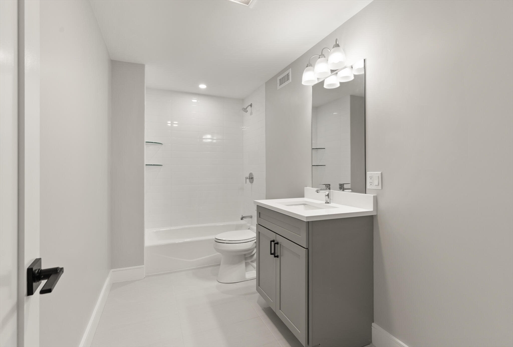 33 Barbara Road Newton, MA 02465 - Photo 33 of 42 a bathroom with a toilet a sink and mirror