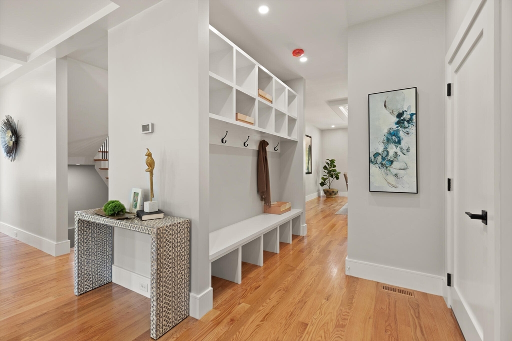 33 Barbara Road Newton, MA 02465 - Photo 7 of 42 a hallway with furniture and wooden floor