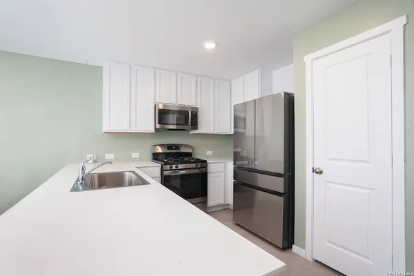 a kitchen with a refrigerator stove and microwave