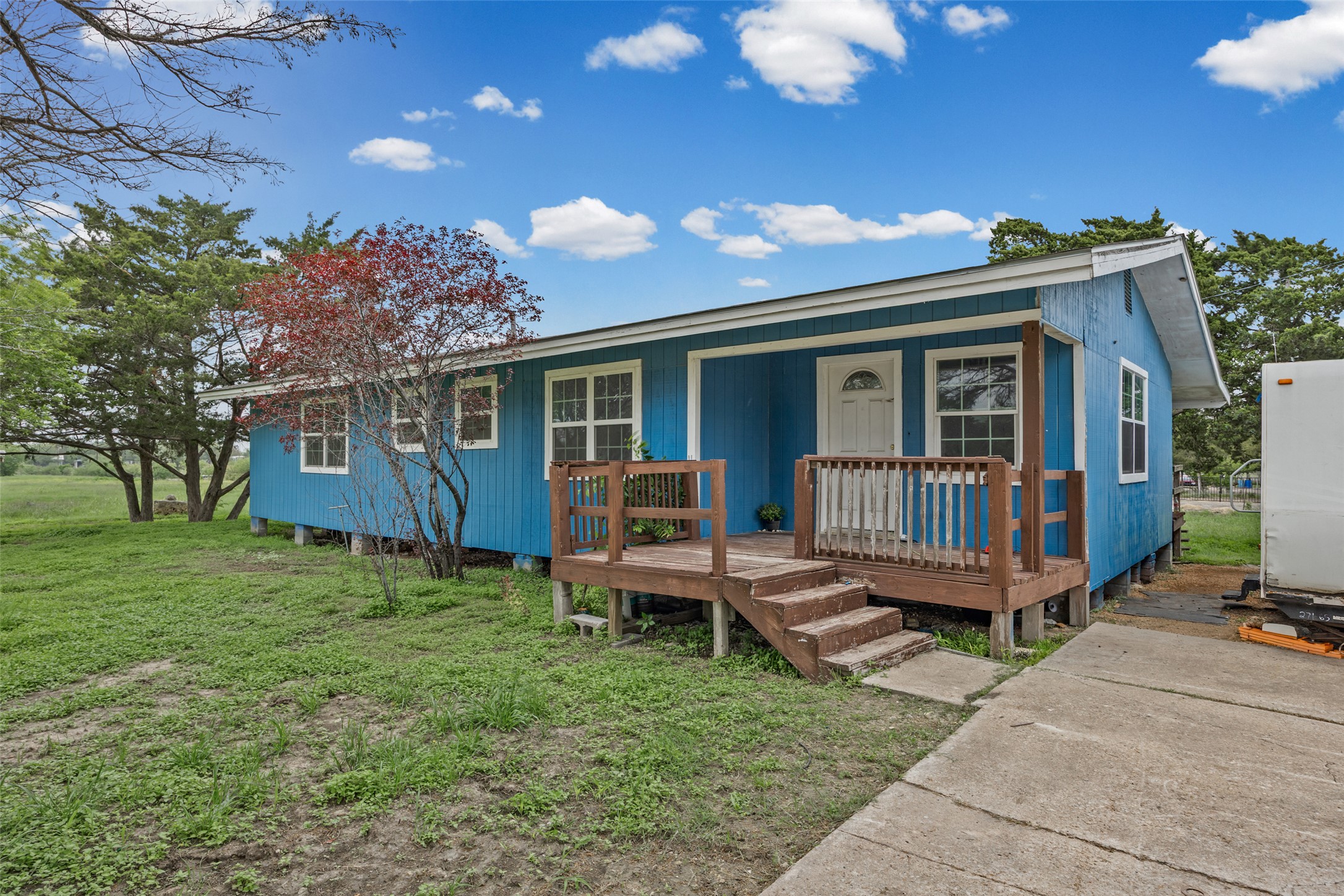 11622 Doyle Overton Road Austin, TX 78719 - Photo 1 of 20 a view of a house with a backyard and wooden deck