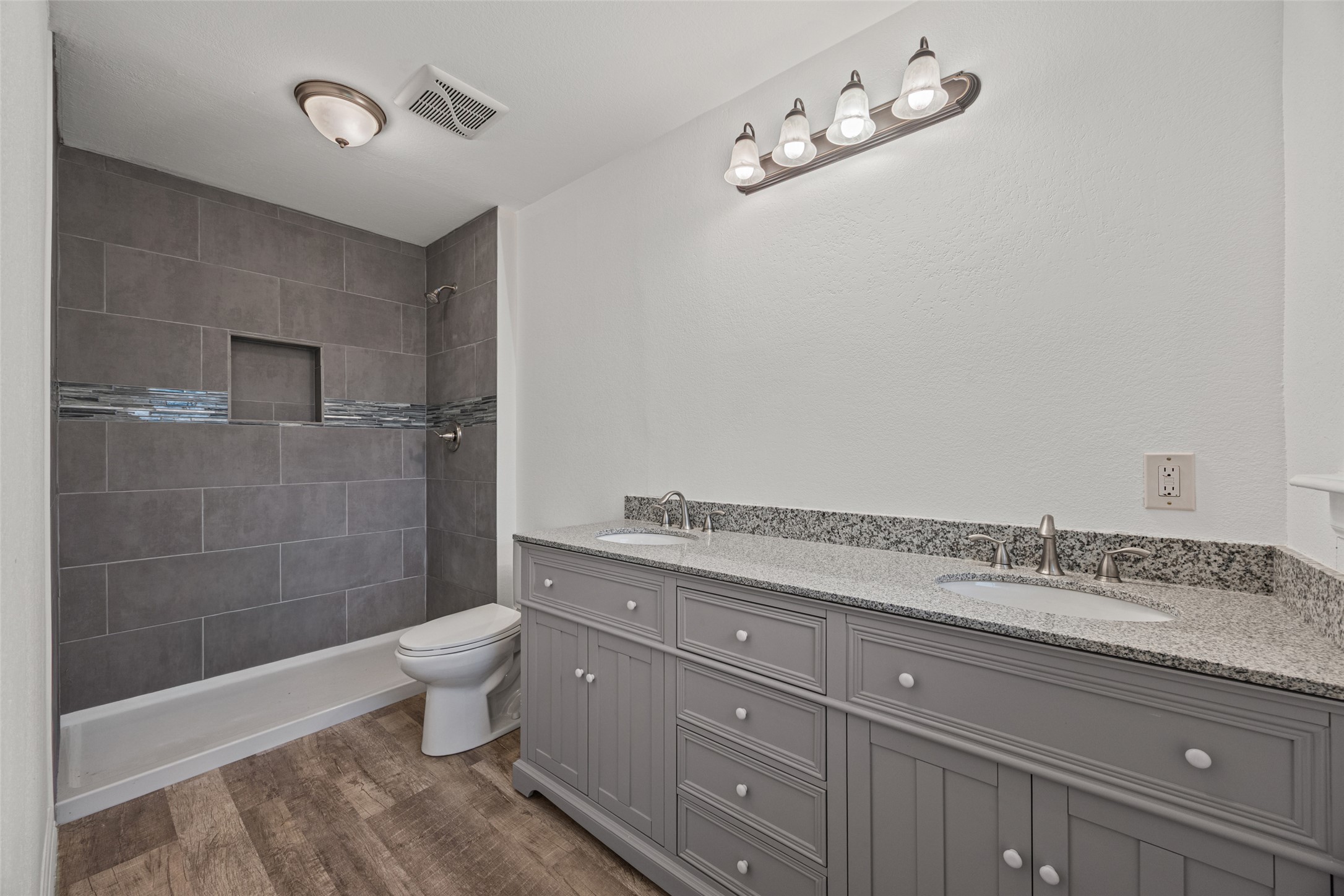 11622 Doyle Overton Road Austin, TX 78719 - Photo 6 of 20 a spacious bathroom with a granite countertop sink a toilet and shower