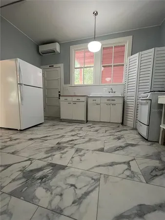 a kitchen with a sink cabinets and window