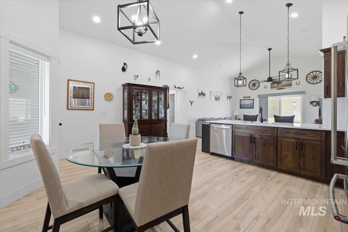 918 Sierra Street Vale, OR 97918 - Photo 19 of 42 Vaulted ceilings, recessed lighting, wood-finish flooring, dark wood cabinetry, and stainless steel appliances